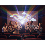 An image showing a room full of people holding up film reels